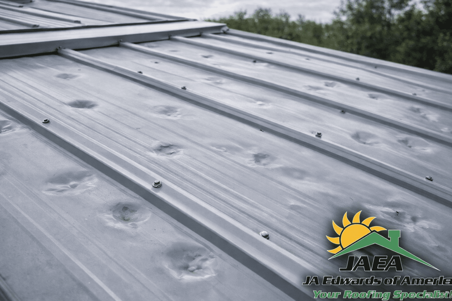 Hail damage dents visible on a metal roof panel