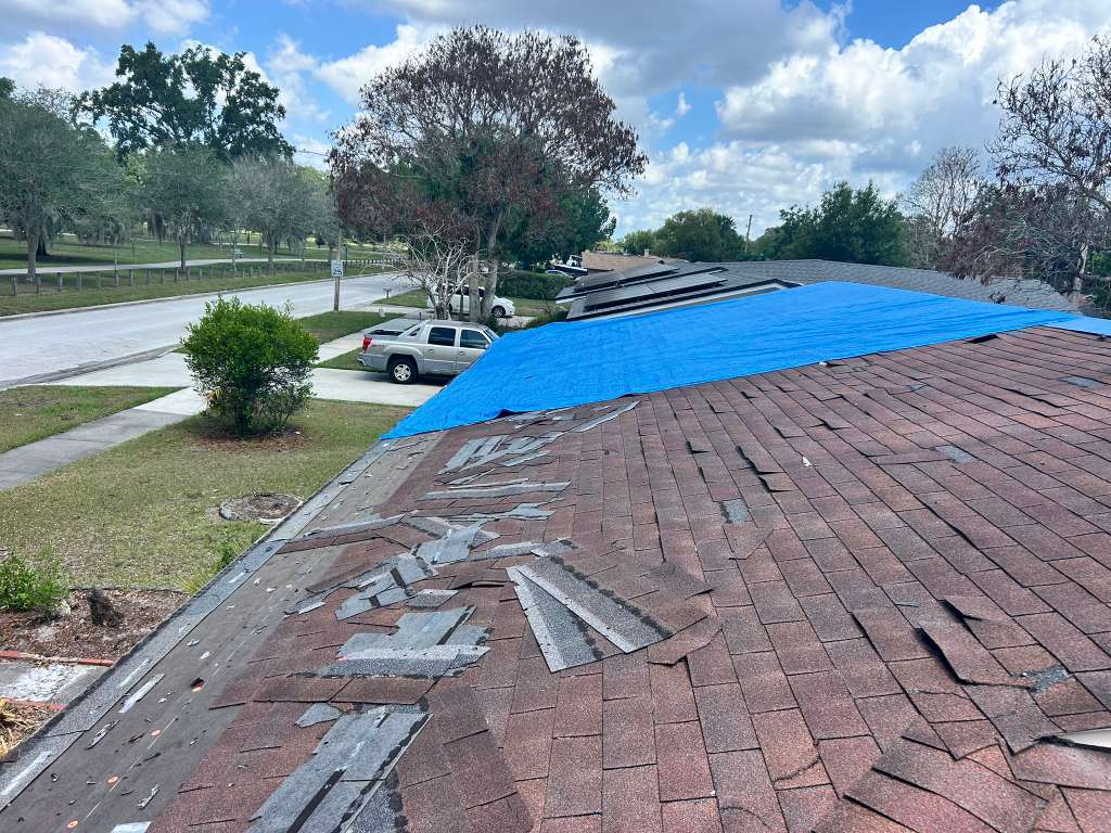 JA Edwards roof inspector checking storm damage on a Florida home