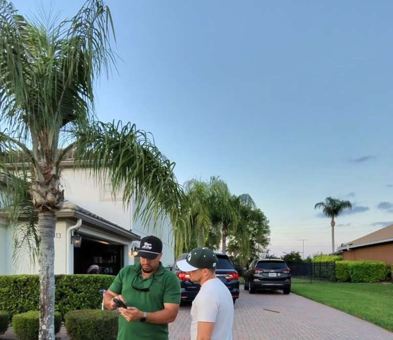 JA Edwards of America roofing professional reviewing a Florida roof inspection with a homeowner